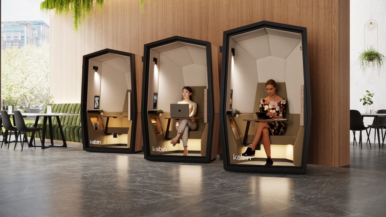 three office privacy pods with people sitting in them